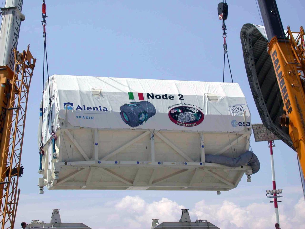 JSC2003-E-40264 (30 May 2003) --- The International Space Station U.S. Node 2 module is hoisted into an Airbus Beluga heavy-lift aircraft.  The aircraft departed May 30 from Turin, Italy and arrived at the Kennedy Space Center June 1 with Node 2. Under contract of the Italian Space Agency (ASI), Alenia Spazio led a consortium of European sub-contractors to build Node 2. The module was built for NASA under a barter agreement with the European Space Agency (ESA) in exchange for the launch of the European Columbus Laboratory by the space shuttle to the International Space Station. Node 2 will provide a passageway between four International Space Station science experiment modules: the U.S. Destiny Laboratory, the Kibo Japanese Experiment Module, the European Columbus Laboratory and the Centrifuge Accommodation Module.  The addition of Node 2 to the station will signify the U.S. Core Complete stage of assembly, at which time the station can support the addition of international laboratories from Europe and Japan.  Photo   Credit: Italian Space Agency (ASI)
