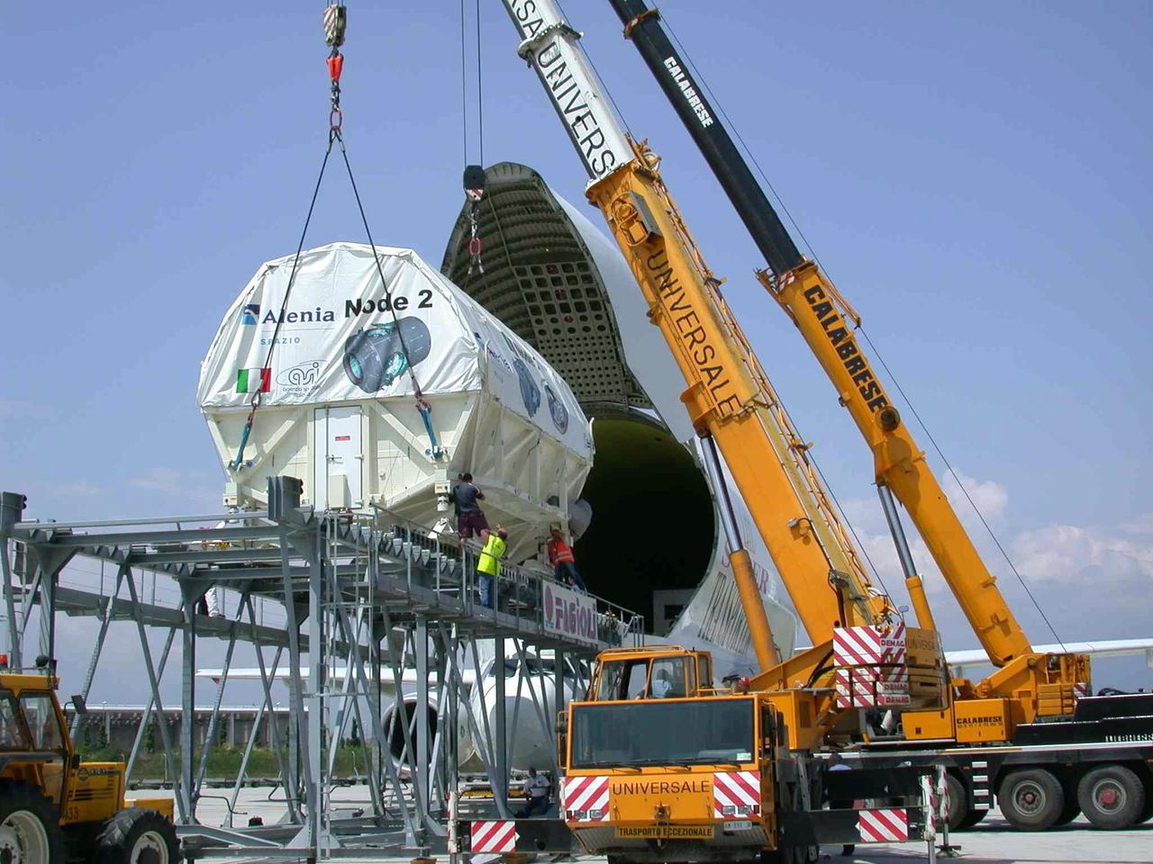 JSC2003-E-40266  (30 May 2003) --- The International Space Station U.S. Node 2 module is hoisted into an Airbus Beluga heavy-lift aircraft.  The aircraft departed May 30 from Turin, Italy and arrived at the Kennedy Space Center June 1 with Node 2.  Under contract of the Italian Space Agency (ASI), Alenia Spazio led a consortium of European sub-contractors to build Node 2. The module was built for NASA under a barter agreement with the European Space Agency (ESA) in exchange for the launch of the European Columbus Laboratory by the space shuttle to the International Space Station.  Node 2 will provide a passageway between four International Space Station science experiment modules: the U.S. Destiny Laboratory, the Kibo Japanese Experiment Module, the European Columbus Laboratory and the Centrifuge Accommodation Module.  The addition of Node 2 to the station will signify the U.S. Core Complete stage of assembly, at which time the station can support the addition of international laboratories from Europe and Japan. Photo    Credit: Italian Space Agency (ASI)