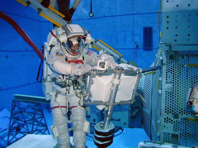 JSC2004-E-13022 (2 March 2004) --- Japanese Aerospace and Exploration Agency (JAXA) Astronaut Soichi Noguchi, the lead space walker for the Space Shuttle's return to flight on mission STS-114, checks a potential repair technique for the Shuttle's heat protection tiles in Johnson Space Center's (JSC) Neutral Buoyancy Laboratory (NBL) pool. The checkout session was conducted on March 2, 2004, and checked the latest techniques and hardware under development for Noguchi to use during an in-flight test of new Shuttle heat shield repair possibilities during STS-114. The mission is now targeted for launch no earlier than the spring of 2005.