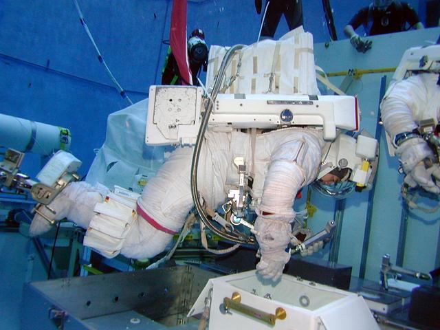 JSC2004-E-13024 (2 March 2004) --- Japanese Aerospace and Exploration Agency (JAXA) Astronaut Soichi Noguchi, the lead space walker for the Space Shuttle's return to flight on mission STS-114, checks a potential repair technique for the Shuttle's heat protection tiles in Johnson Space Center's (JSC) Neutral Buoyancy Laboratory (NBL) pool. The checkout session was conducted on March 2, 2004, and checked the latest techniques and hardware under development for Noguchi to use during an in-flight test of new Shuttle heat shield repair possibilities during STS-114. The mission is now targeted for launch no earlier than the spring of 2005.
