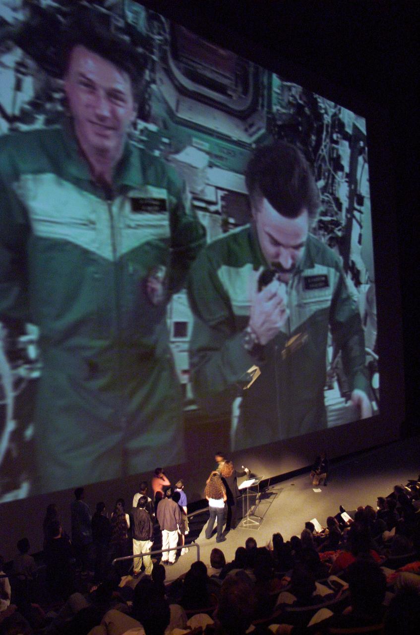 JSC2004-E-15422 (30 March 2004) --- Questions came from students and teachers from Alvin, Clear Creek, Friendswood, Galena Park, Galveston and Pasadena Independent School Districts who gathered at Space Center Houston to talk with the Expedition 8 crew aboard the International Space Station on March 30, 2004. Live images of astronaut C. Michael Foale and cosmonaut Alexander Kaleri are seen on the large screen, as the two interact with the ground audience. (Teaching from Space)