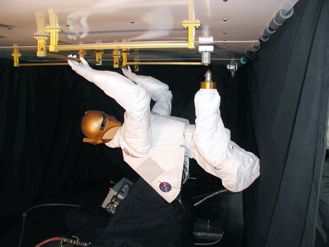 JSC2004-E-16343 (March 2004) --- Robonaut &#0150; which uses a head, torso, arms and dexterous hands to perform tasks using the same tools used by human spacewalkers &#0150; was fitted with a movable leg that ended in a &#0147;foot&#0148; that was a common interface for the standard Work Interface Facility (WIF) anchors on the International Space Station (ISS). The Robonaut Project is a collaborative effort with the Defense Advanced Research Projects Agency (DARPA), and has been under development at Johnson Space Center (JSC) for several years.