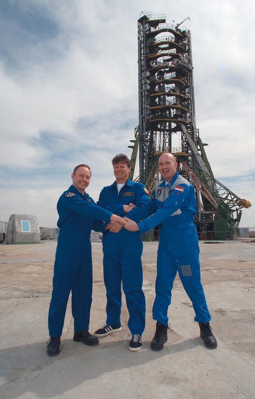 JSC2004-E-19694 (14 April 2004) --- Astronaut Edward M. (Mike) Fincke (left), NASA International Space Station (ISS) science officer and flight engineer; cosmonaut Gennady I. Padalka (center), Russia’s Federal Space Agency Expedition 9 mission commander; and European Space Agency (ESA) astronaut Andre Kuipers of the Netherlands pose for a photo during a tour of the Soyuz launch pad, Baikonur, Kazakhstan. The trio is scheduled to launch on April 19, 2004, to the ISS for arrival on April 21. Padalka and Fincke will spend six months on the ISS, replacing the Expedition 8 crew, which has been aboard the Station since October 20, 2003. European Space Agency (ESA) astronaut Andre Kuipers of the Netherlands, who is flying under a commercial contract between ESA and Russia’s Federal Space Agency, will return to Earth with the Expedition 8 crew on April 30, 2004. Photo Credit: NASA/Bill Ingalls