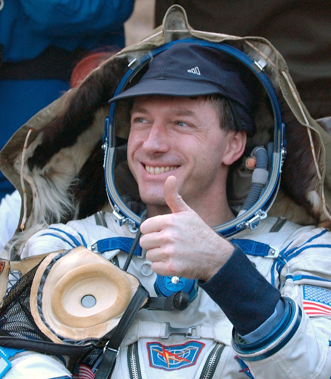 JSC2004-E-21242 (30 April 2004) --- Astronaut C. Michael Foale, Expedition 8 commander and NASA ISS science officer, gives thumbs up after he and his crewmates, cosmonaut Alexander Y. Kaleri, Soyuz flight engineer representing Russia?s Federal Space Agency, and European Space Agency (ESA) astronaut Andre Kuipers of the Netherlands, successfully landed in north central Kazakhstan on April 30, 2004, in their Soyuz TMA-3 capsule. Foale and Kaleri completed 195 days in space aboard the International Space Station (ISS), while Kuipers returned after an 11-day research mission as part of a commercial agreement between ESA and Russia?s Federal Space Agency. Photo credit: NASA/Bill Ingalls