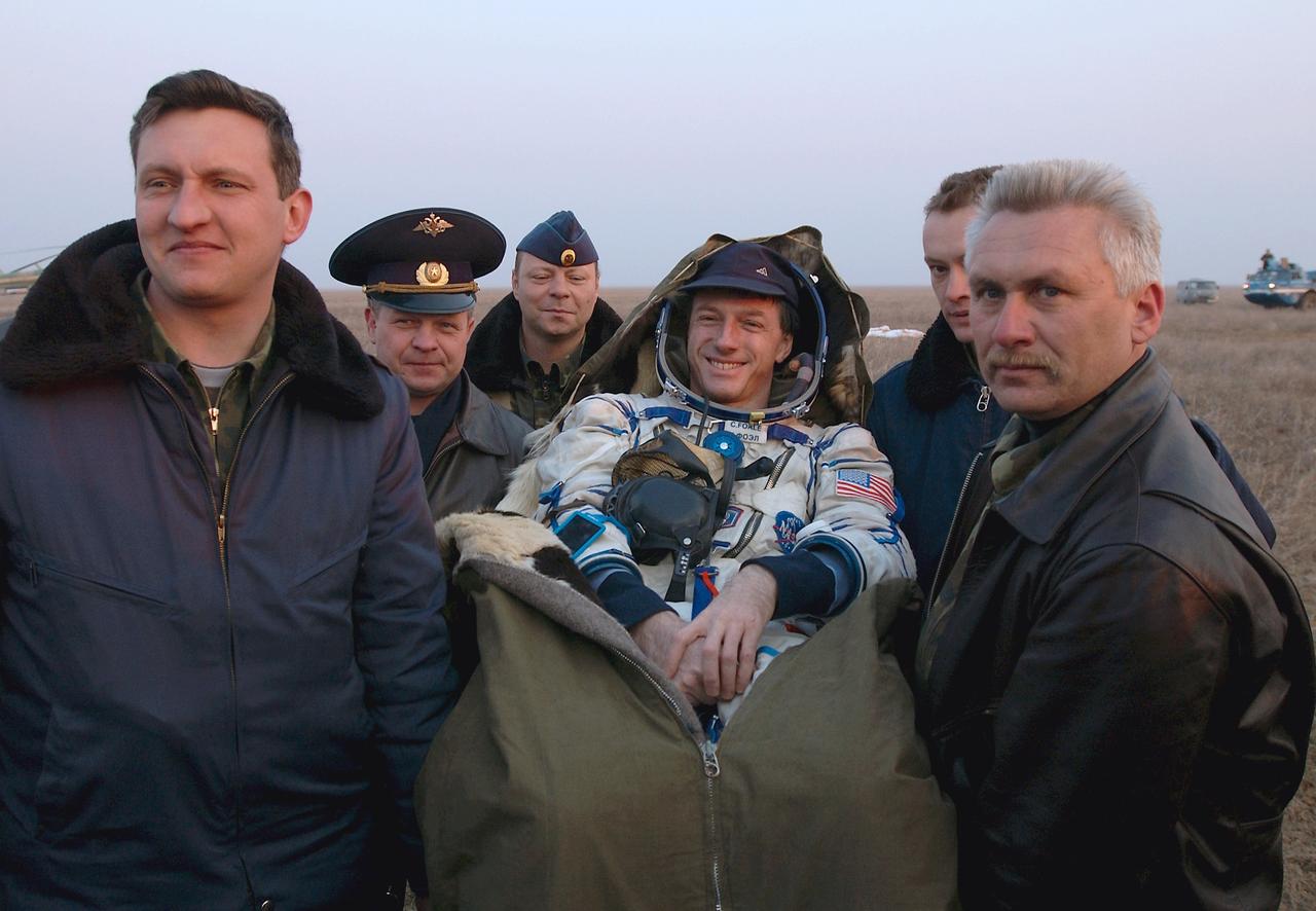 JSC2004-E-21252 (30 April 2004) --- Astronaut C. Michael Foale, Expedition 8 commander and NASA ISS science officer, is carried in a chair from the Soyuz landing site to an inflatable medical tent after he and his crewmates, cosmonaut Alexander Y. Kaleri (out of frame), Soyuz flight engineer representing Russia’s Federal Space Agency, and European Space Agency (ESA) astronaut Andre Kuipers (out of frame) of the Netherlands, successfully landed in north central Kazakhstan on April 30, 2004, in their Soyuz TMA-3 capsule. Foale and Kaleri completed 195 days in space aboard the International Space Station (ISS), while Kuipers returned after an 11-day research mission as part of a commercial agreement between ESA and Russia’s Federal Space Agency. Photo Credit: NASA/Bill Ingalls