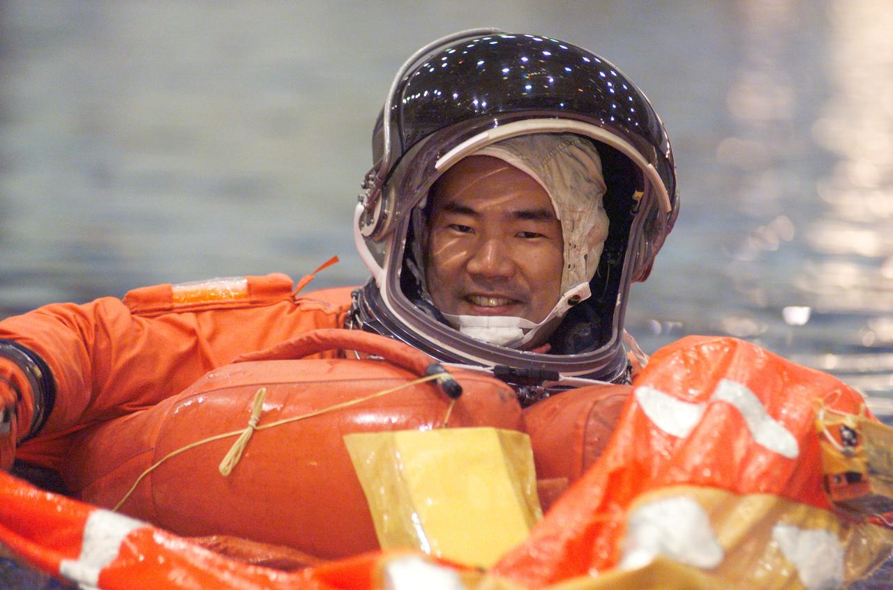 JSC2004-E-41402 (17 September 2004) --- Astronaut Soichi Noguchi, STS-114 mission specialist representing the Japan Aerospace Exploration Agency (JAXA), attired in a training version of the shuttle launch and entry suit, floats in a small life raft during an emergency egress training session in the Neutral Buoyancy Laboratory (NBL) near the Johnson Space Center (JSC).