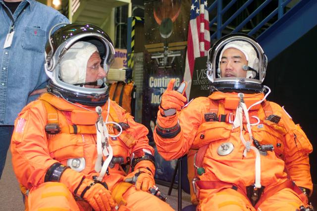JSC2004-E-42291 (24 September 2004) --- Astronaut Charles J. Camarda (left) and JAXA astronaut Soichi Noguchi, both STS-114 mission specialists, attired in training versions of the shuttle launch and entry suit, await the start of a mission training session in the Space Vehicle Mockup Facility at Johnson Space Center (JSC).