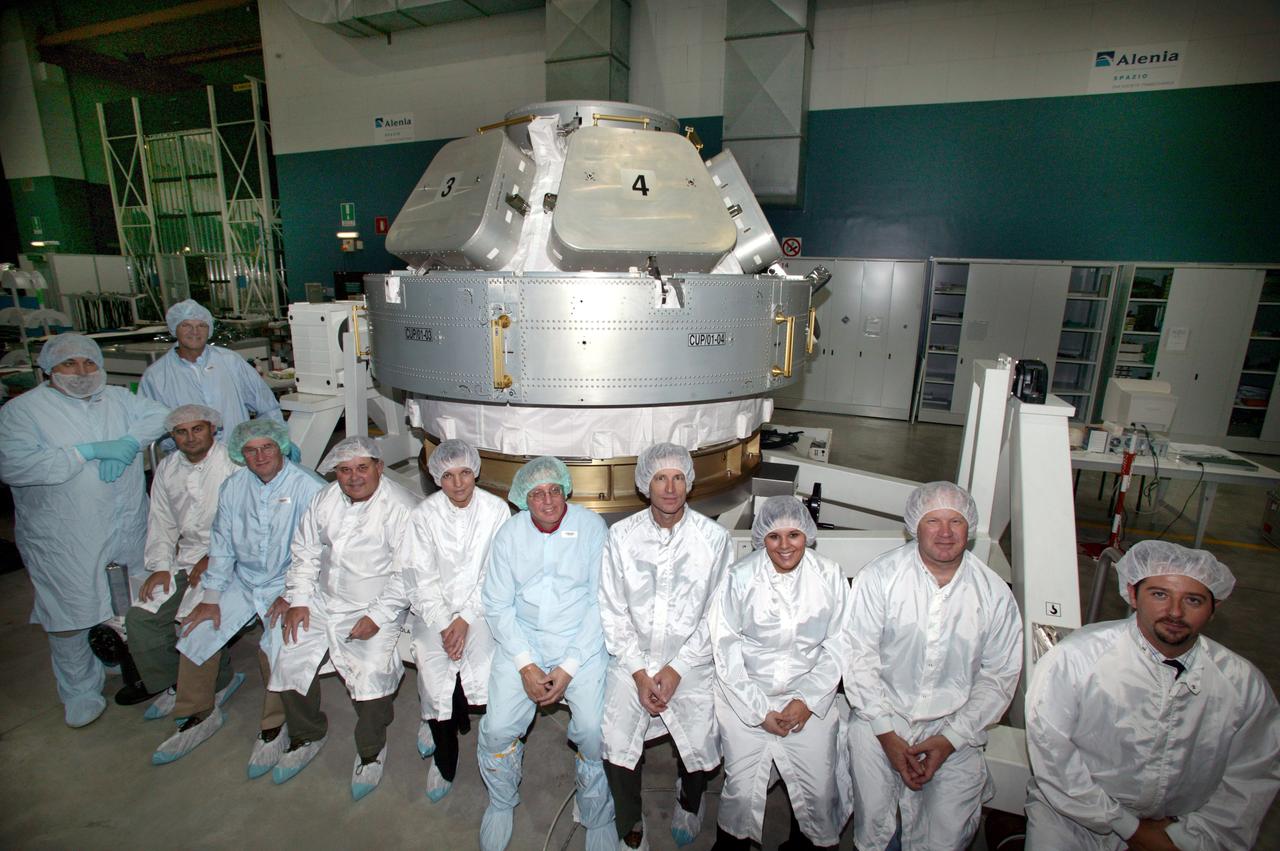 JSC2004-E-44646 (September 2004) --- Engineers and technicians who have been working hard on the International Space Station's Cupola are pictured with the hardware in the Alenia Spazio clean room in Turin, Italy. The personnel have been preparing the hardware for shipment to NASA's launch facility at Cape Kennedy, Florida. From inside the Cupola, a dome-shaped module with seven windows, astronauts have a panoramic view for observing operations on the outside of the orbiting complex. The Cupola module provides external observation capabilities during spacewalks, docking operations, hardware surveys and for Earth and celestial studies. It also serves as the primary location for executing robot arm operations of Canadarm2. Until the Cupola is installed, crews have been using a robotic control computer station located in the Destiny Laboratory to operate the arm. The Cupola’s windows enhance the robotic arm operator's situational awareness, supplementing camera and graphic views provided by the computer workstation. Photo Credit: Alenia Spazio