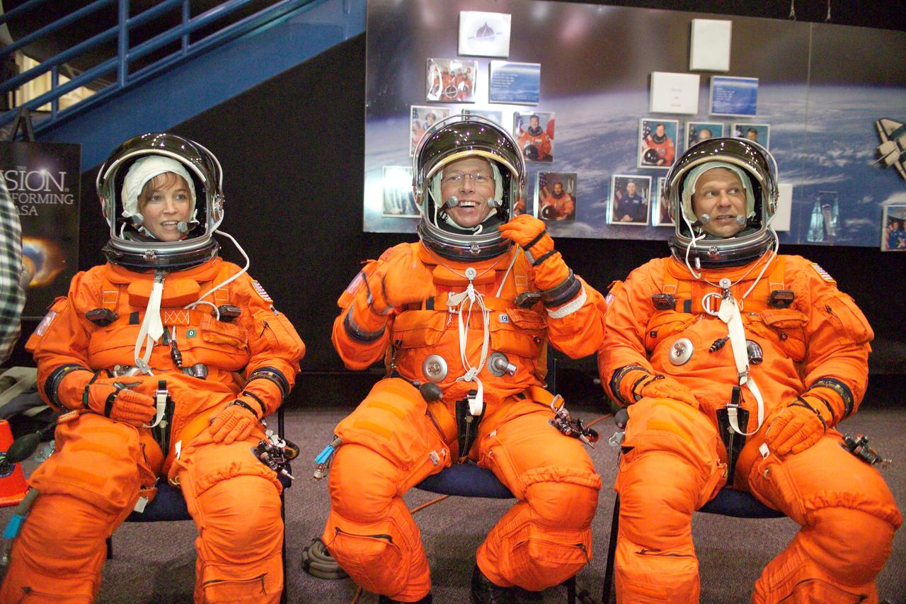 JSC2005-E-03861 (28 January 2005) --- Astronauts Lisa M. Nowak (left), Michael E. Fossum and Piers J. Sellers, all STS-121 mission specialists, attired in training versions of the shuttle launch and entry suit, await the start of an emergency egress training session in the crew compartment trainer (CCT-1). The CCT is one of several shuttle-training components located in the Space Vehicle Mockup Facility at the Johnson Space Center (JSC).