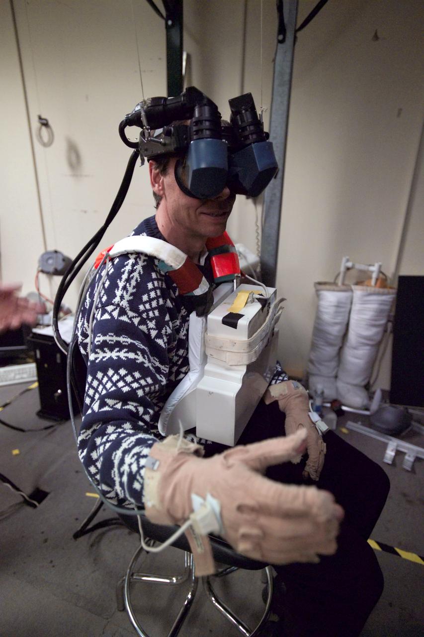 JSC2005-E-04513 (3 Feb. 2005) --- European Space Agency (ESA) astronaut Christer Fuglesang, STS-116 mission specialist, uses virtual reality hardware in the Space Vehicle Mockup Facility at the Johnson Space Center to rehearse some of his duties on the upcoming mission to the international space station. This type of virtual reality training allows the astronauts to wear a helmet and special gloves while looking at computer displays simulating actual movements around the various locations on the station hardware with which they will be working.