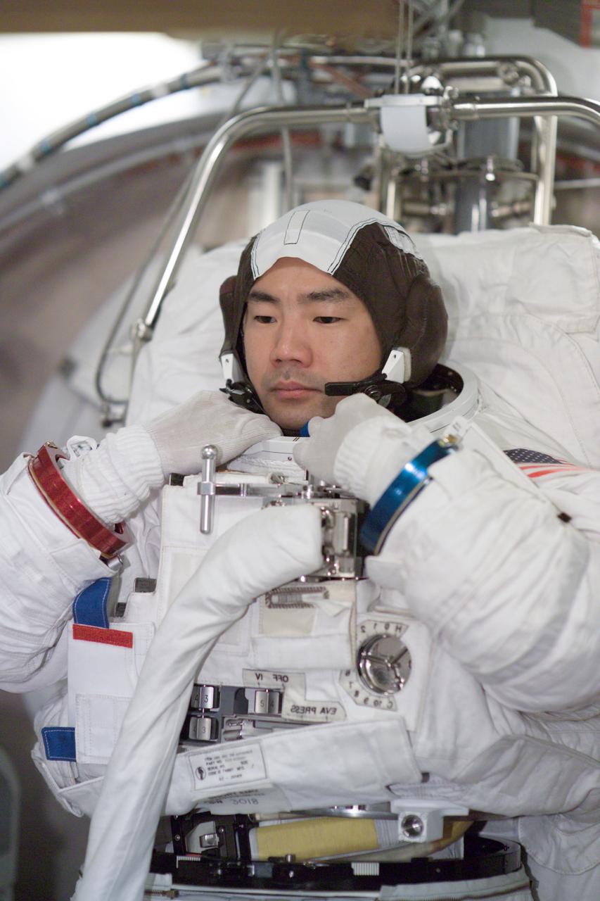 JSC2005-E-12411 (29 March 2005) --- Astronaut Soichi Noguchi, STS-114 mission specialist representing the Japan Aerospace Exploration Agency (JAXA), participates in an Extravehicular Mobility Unit (EMU) spacesuit fit check in the Space Station Airlock Test Article (SSATA) in the Crew Systems Laboratory at the Johnson Space Center (JSC).