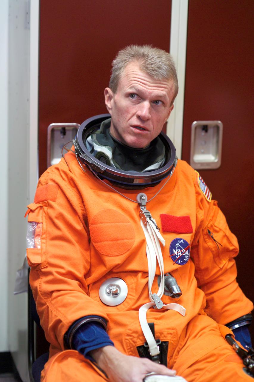 JSC2005-E-13773 (5 April 2005) --- Astronaut Brent W. Jett Jr., STS-115 commander, attired in a training version of the shuttle launch and entry suit, awaits the start of an emergency egress training session in the Space Vehicle Mockup Facility at the Johnson Space Center.