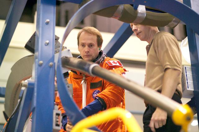 NASA image: STS-115 crew during crew bailout (91020) training in crew compartment trainer.