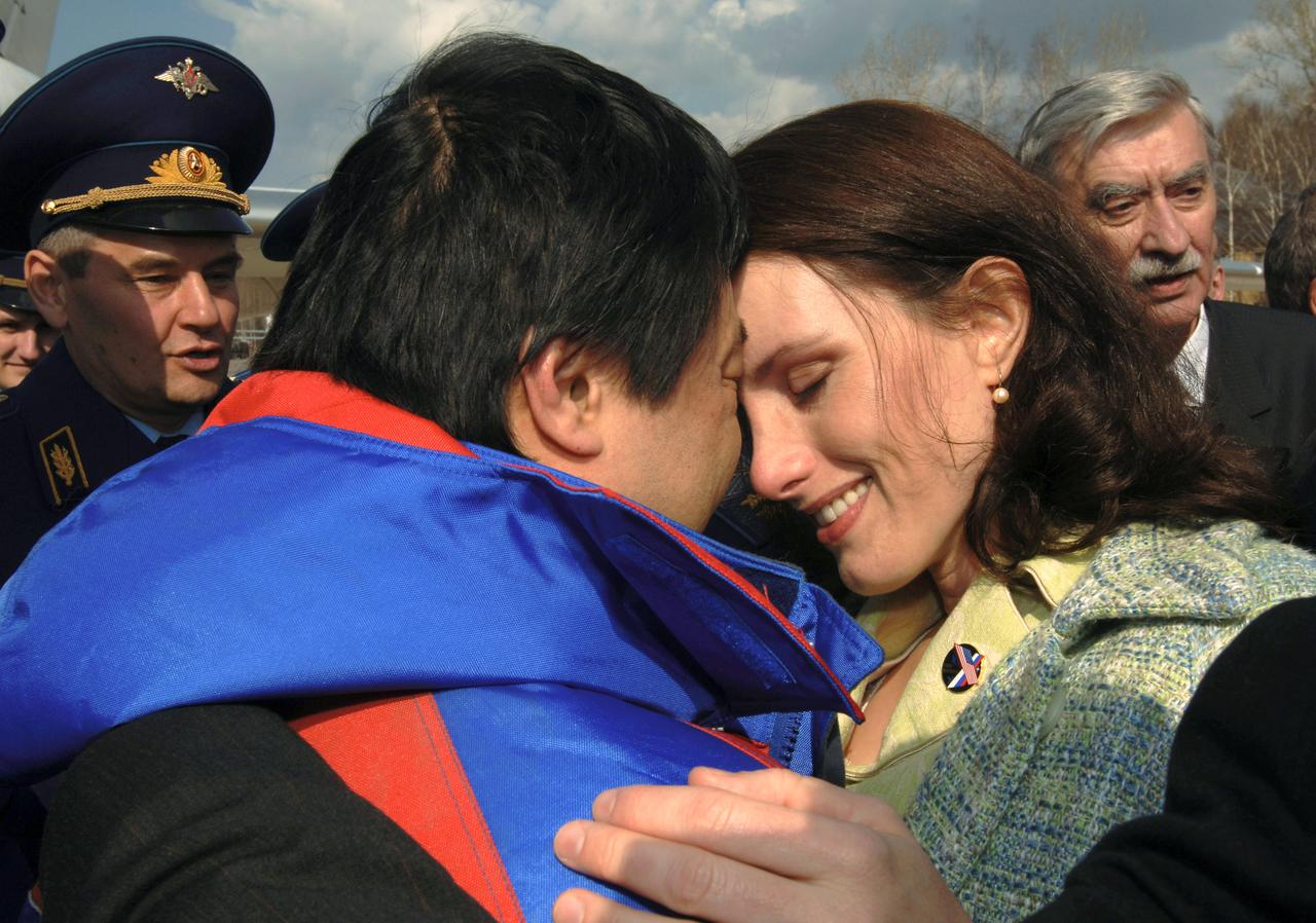 JSC2005-E-17967 (25 April 2005) --- Astronaut Leroy Chiao, Expedition 10 commander and NASA ISS science officer, is greeted by his wife after arriving back to Star City, Russia. Chiao; cosmonaut Salizhan S. Sharipov (not pictured), flight engineer representing Russia's Federal Space Agency; and European Space Agency (ESA) astronaut Roberto Vittori (not pictured) of Italy brought their Soyuz TMA-5 capsule to a pre-dawn landing on April 25, 2005 (Kazakhstan time) northeast of the Kazakhstan town of Arkalyk to wrap up a six month mission aboard the International Space Station (ISS) for Chiao and Sharipov and a ten-day mission for Vittori. The twice-flown Italian astronaut participated under a commercial contract between ESA and the Russian Federal Space Agency. Photo Credit: NASA/Bill Ingalls