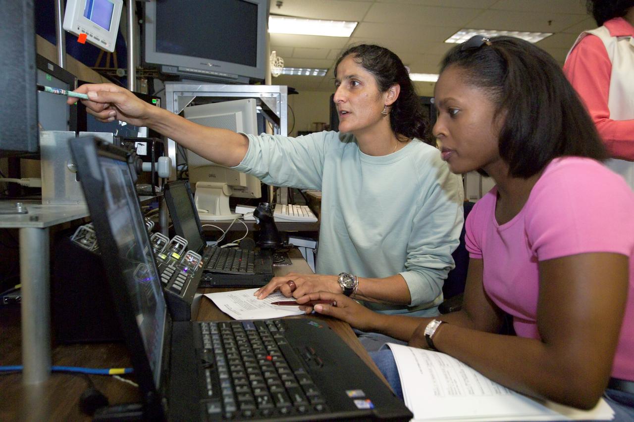 JSC2005-E-18147 (6 May 2005) --- Astronauts Sunita L. Williams (left), Expedition 14 flight engineer, and Joan E. Higginbotham, STS-116 mission specialist, use the virtual reality lab at the Johnson Space Center to train for their duties aboard the space shuttle. This type of computer interface, paired with virtual reality training hardware and software, helps to prepare the entire team for dealing with space station elements. Williams will join Expedition 14 in progress and serve as a flight engineer after traveling to the station on space shuttle mission STS-116.