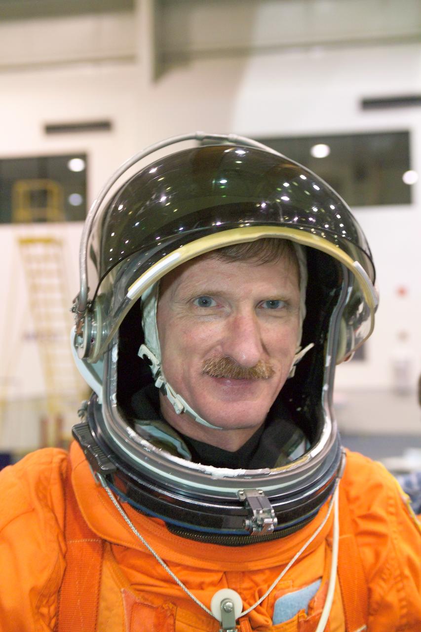 JSC2005-E-19180 (11 May 2005) --- Astronaut Joseph R. (Joe) Tanner, STS-115 mission specialist, attired in a training version of the shuttle launch and entry suit, awaits the start of a water survival training session in the Neutral Buoyancy Laboratory (NBL) near Johnson Space Center.