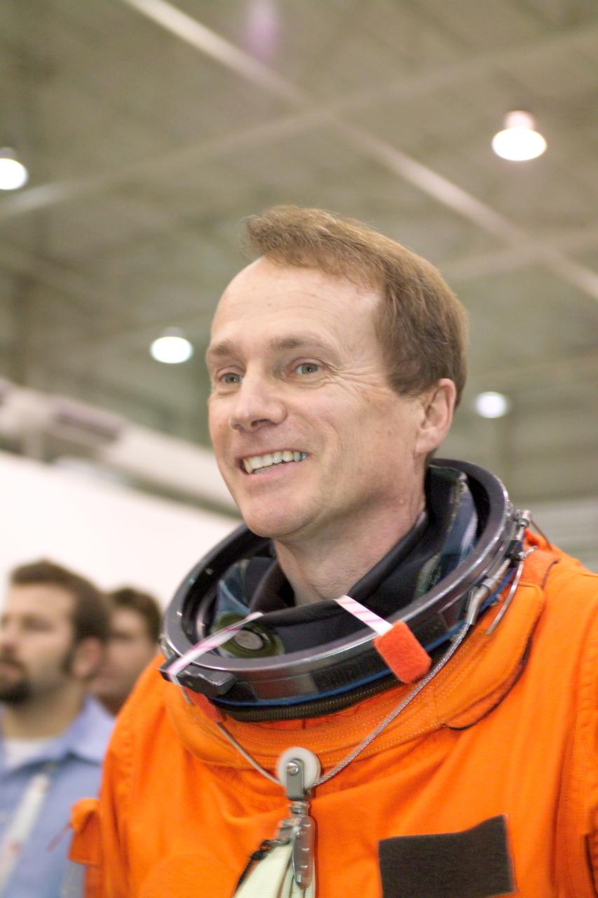 JSC2005-E-19187 (11 May 2005) --- Astronaut Steven G. MacLean, STS-115 mission specialist representing the Canadian Space Agency, attired in a training version of the shuttle launch and entry suit, awaits the start of a water survival training session in the Neutral Buoyancy Laboratory (NBL) near Johnson Space Center.