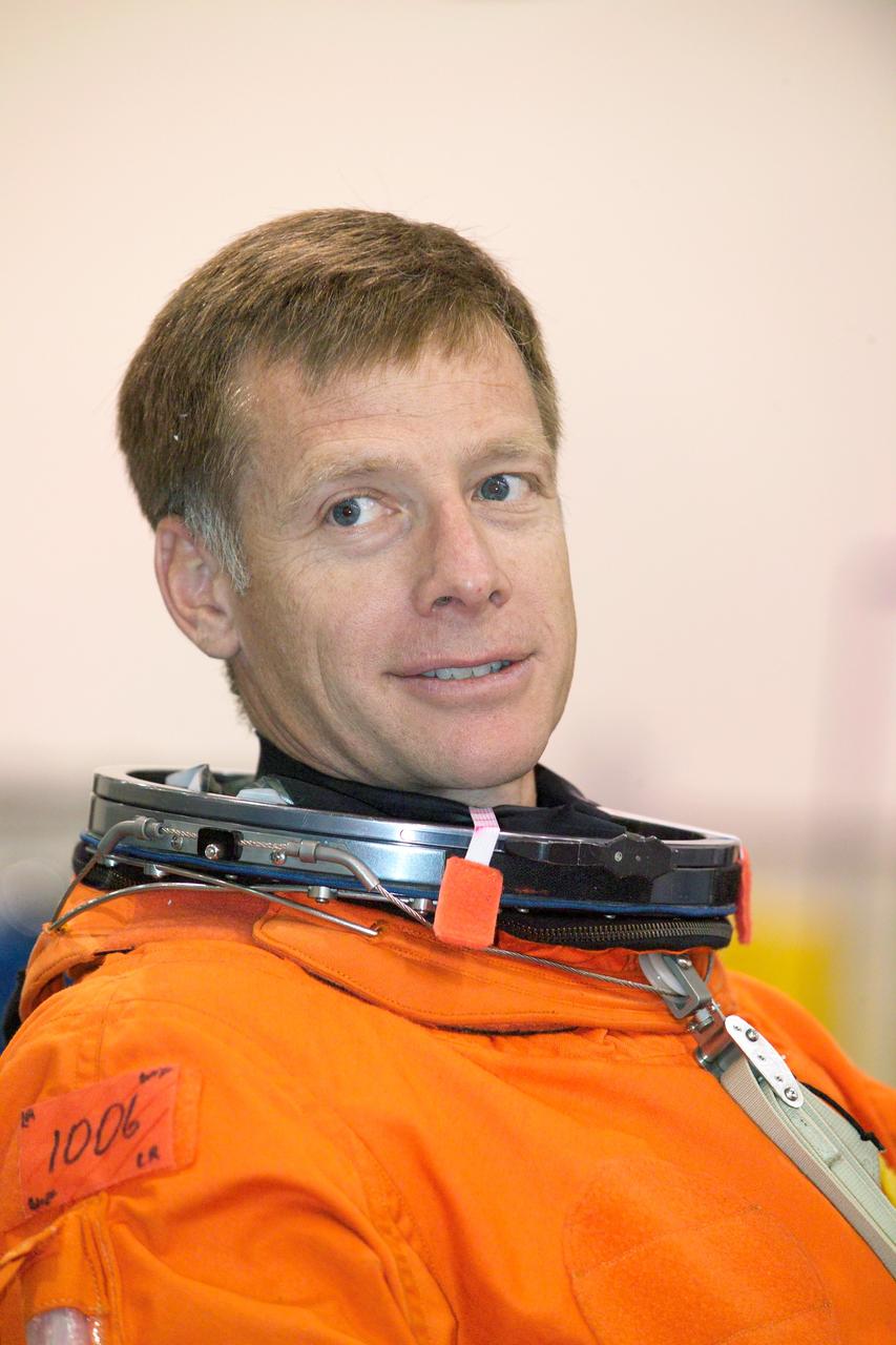 JSC2005-E-19211 (11 May 2005) --- Astronaut Christopher J. Ferguson, STS-115 pilot, attired in a training version of the shuttle launch and entry suit, awaits the start of a water survival training session in the Neutral Buoyancy Laboratory (NBL) near Johnson Space Center.