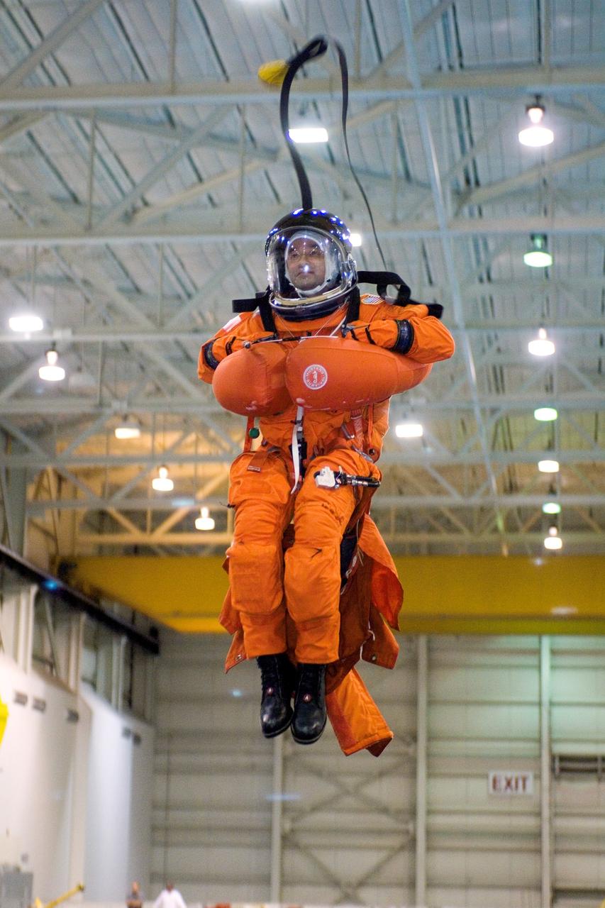 JSC2005-E-31233 (28 July 2005) --- Astronaut Mark L. Polansky, STS-116 commander, attired in a training version of the shuttle launch and entry suit, simulates a parachute drop into water during an emergency bailout training session at the Neutral Buoyancy Laboratory (NBL) near the Johnson Space Center.