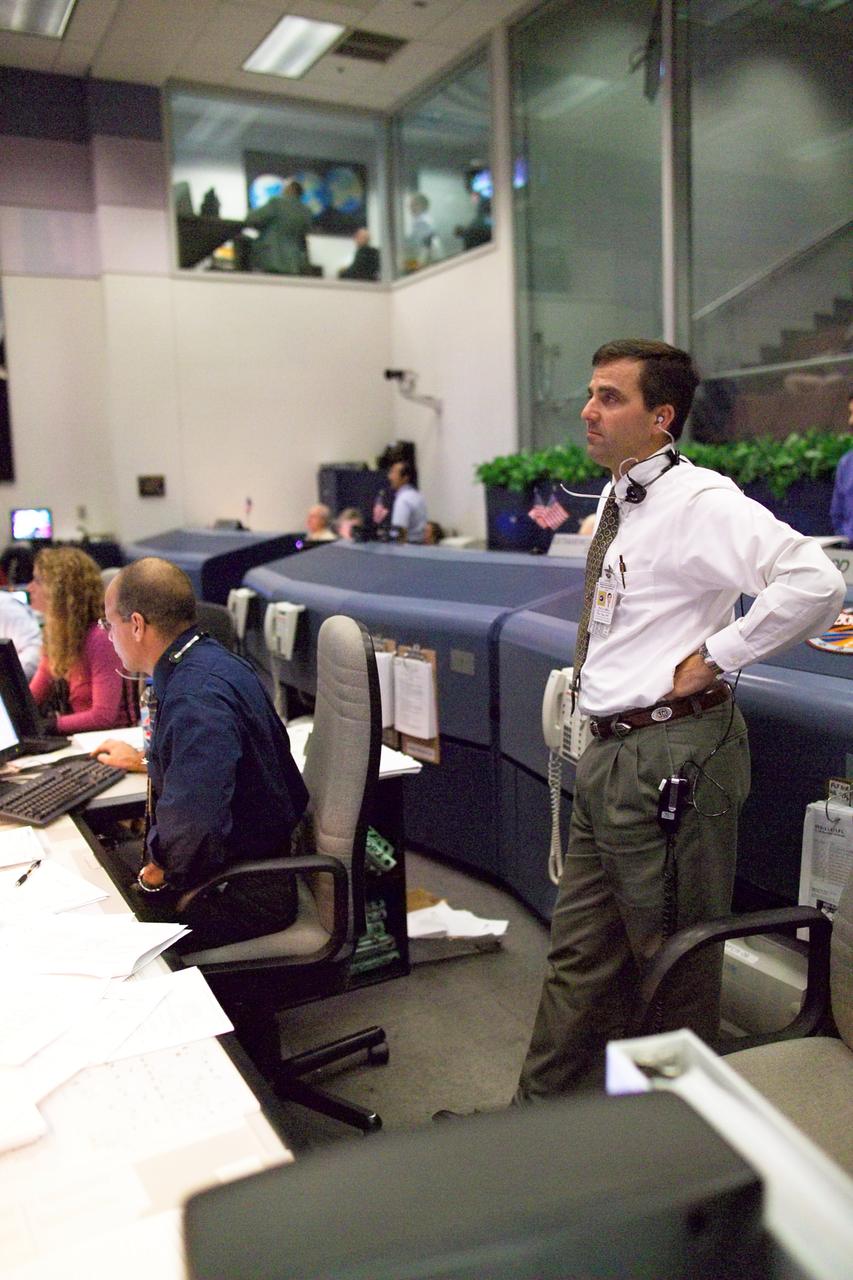 JSC2005-E-31938 (3 August 2005) --- STS114 Lead Flight Director Paul Hill watches televised extravehicular activity (EVA) involving the astronauts of the Space Shuttle Discovery, currently visiting the International Space Station.