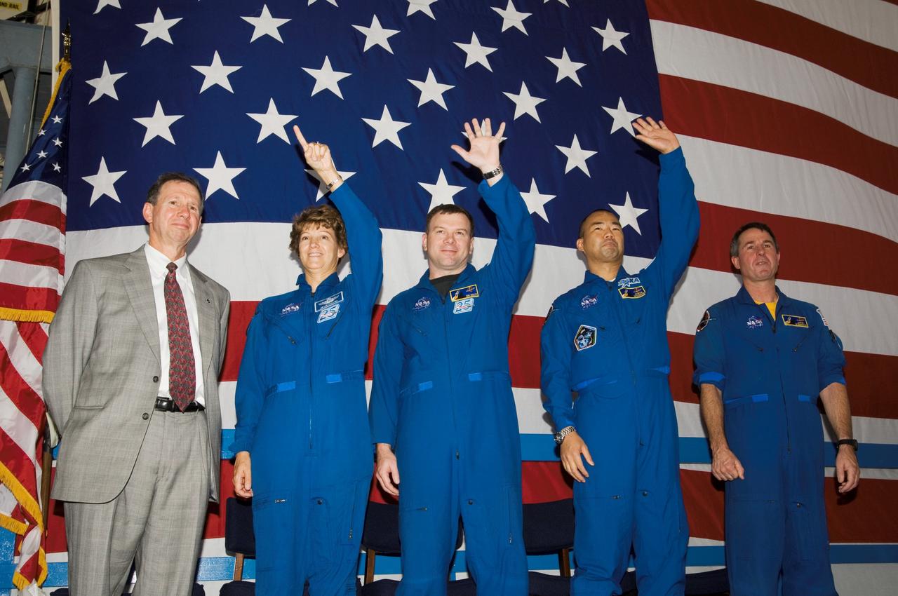 JSC2005-E-33327 (10 August 2005) --- The STS-114 crewmembers wave to a crowd on hand at Ellington Field&#0146;s Hangar 276 near Johnson Space Center (JSC) during the crew return ceremonies. Pictured, from the left, are NASA Administrator Michael Griffin; astronauts Eileen M. Collins, commander; James M. Kelly, pilot; Soichi Noguchi, mission specialist representing Japan Aerospace Exploration Agency (JAXA); and Stephen K. Robinson, mission specialist. Not pictured are astronauts Andrew S. W. Thomas, Wendy B. Lawrence and Charles J. Camarda, mission specialists.