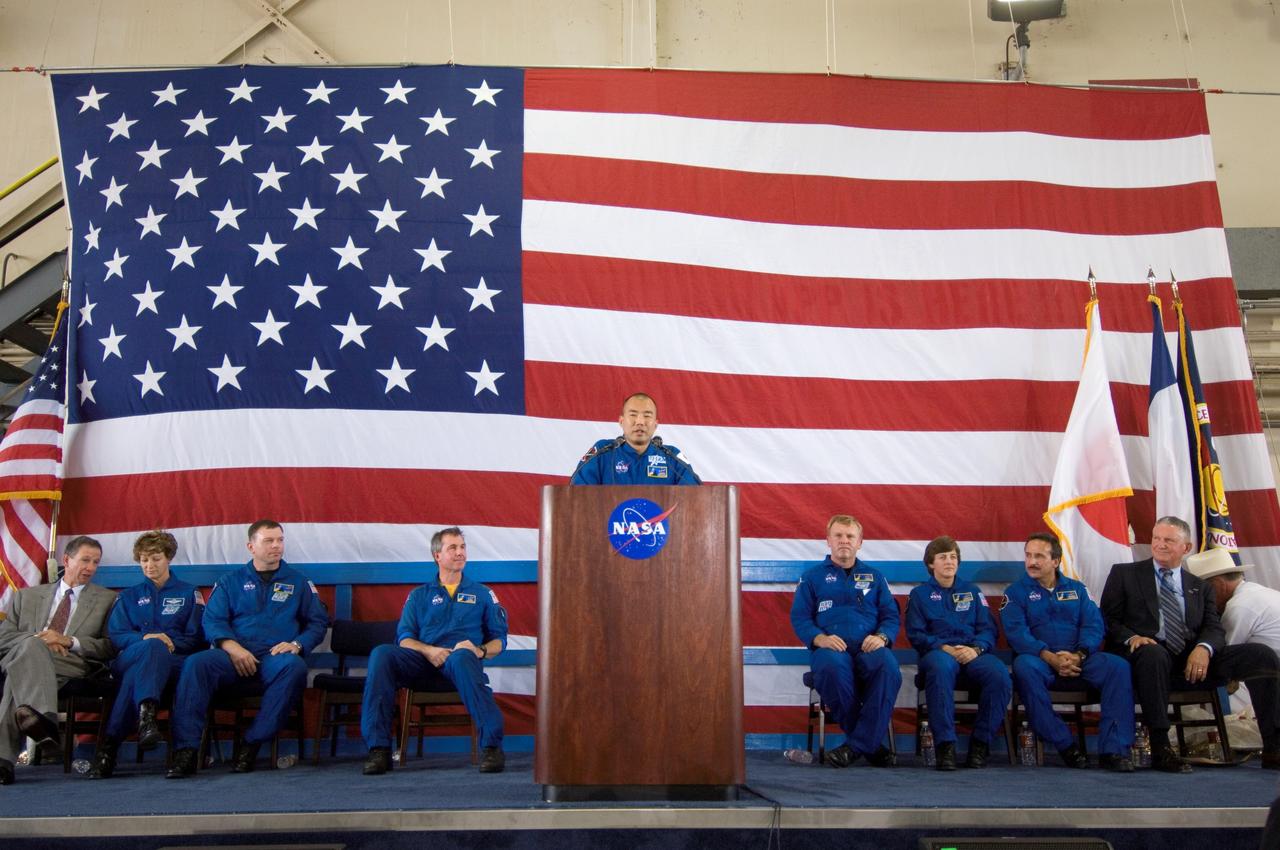 Images from the STS-114 Homecoming Ceremony, held in Hangar 276 at Ellington Field. Crew member Soichi Noguchi speaks to the crowd during the ceremonies. Seated onstage (from left) are NASA Administrator Michael Griffin, crew members Eileen Collins, James Kelly, Stephen Robinson, Andrew Thomas, Wendy Lawrence, Charles Camarda, and Center Director Jefferson Howell.
