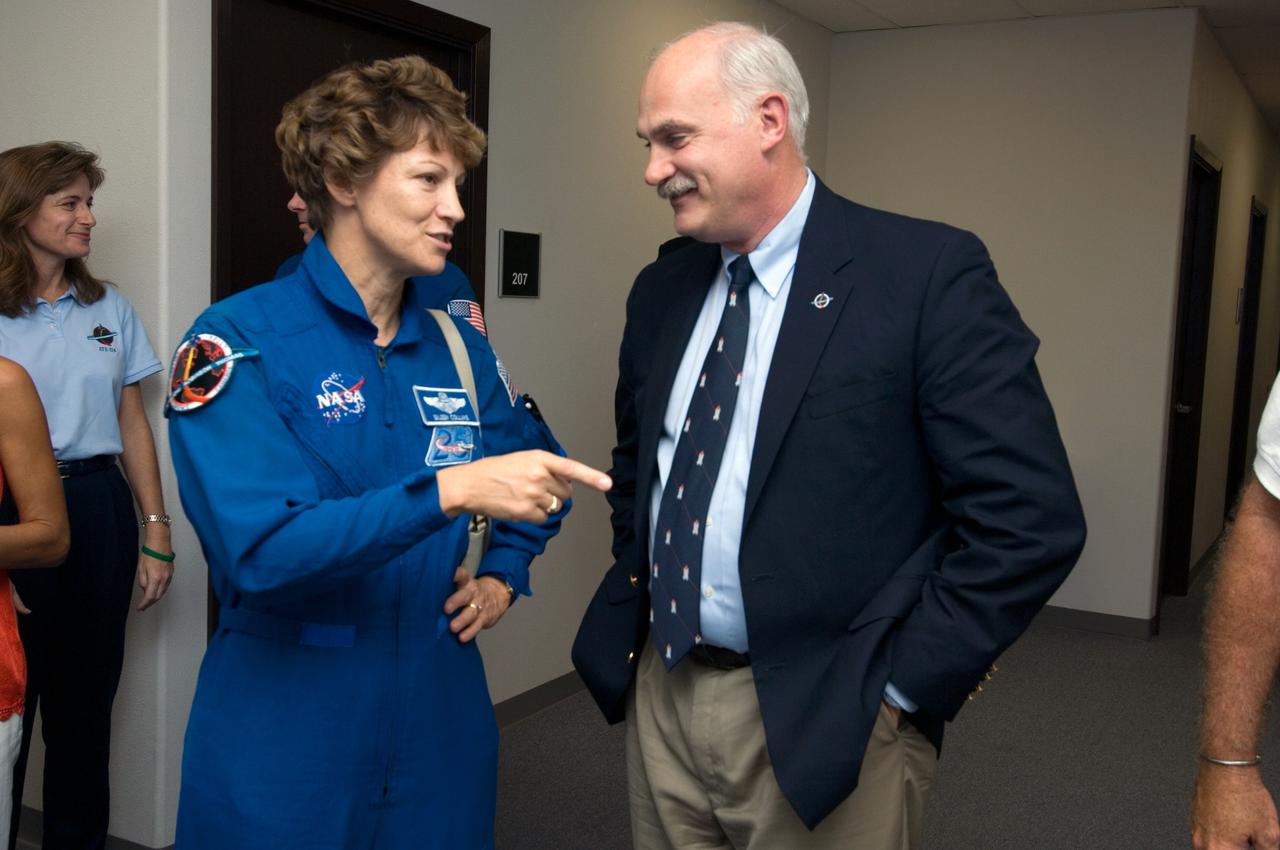 JSC2005-E-33437 (10 August 2005) --- Astronaut Eileen M. Collins, STS-114 commander, and William F. Readdy, Associate Administrator for Space Flight, NASA Headquarters, enjoy a light moment prior to the STS-114 crew return ceremonies at Ellington Field near Johnson Space Center (JSC).