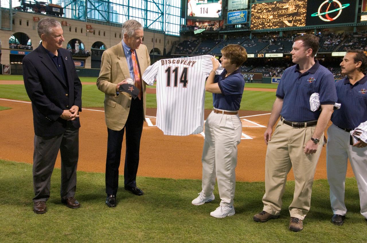 Images from the pregame ceremonies during NASA Night at the Houston Astros game, taken at Minute Maid Park, Houston. View of Center Director Jefferson Howell, Astros owner Drayton McLane, and STS-114 crewmembers Eileen Collins, James Kelly and Charles Camarda, with Collins holding an Astros jersey reading Discovery 114.