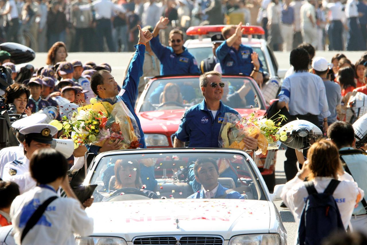 JSC2005-E-40334 (2 October 2005) --- Members of the crew that returned the Space Shuttle to flight earlier this year aboard Discovery, from left, astronaut Soichi Noguchi of the Japan Aerospace  Exploration Agency (JAXA) and NASA astronauts Charles J. Camarda, Stephen K. Robinson and Andrew S.W. Thomas participate in a parade welcoming Noguchi to his hometown of Chigasaki, Kanagawa, Japan on Oct. 2. The Discovery crew visited Japan this week as guests of JAXA, participating in a variety of public events.  Photo Credit: Japan Aerospace Exploration Agency