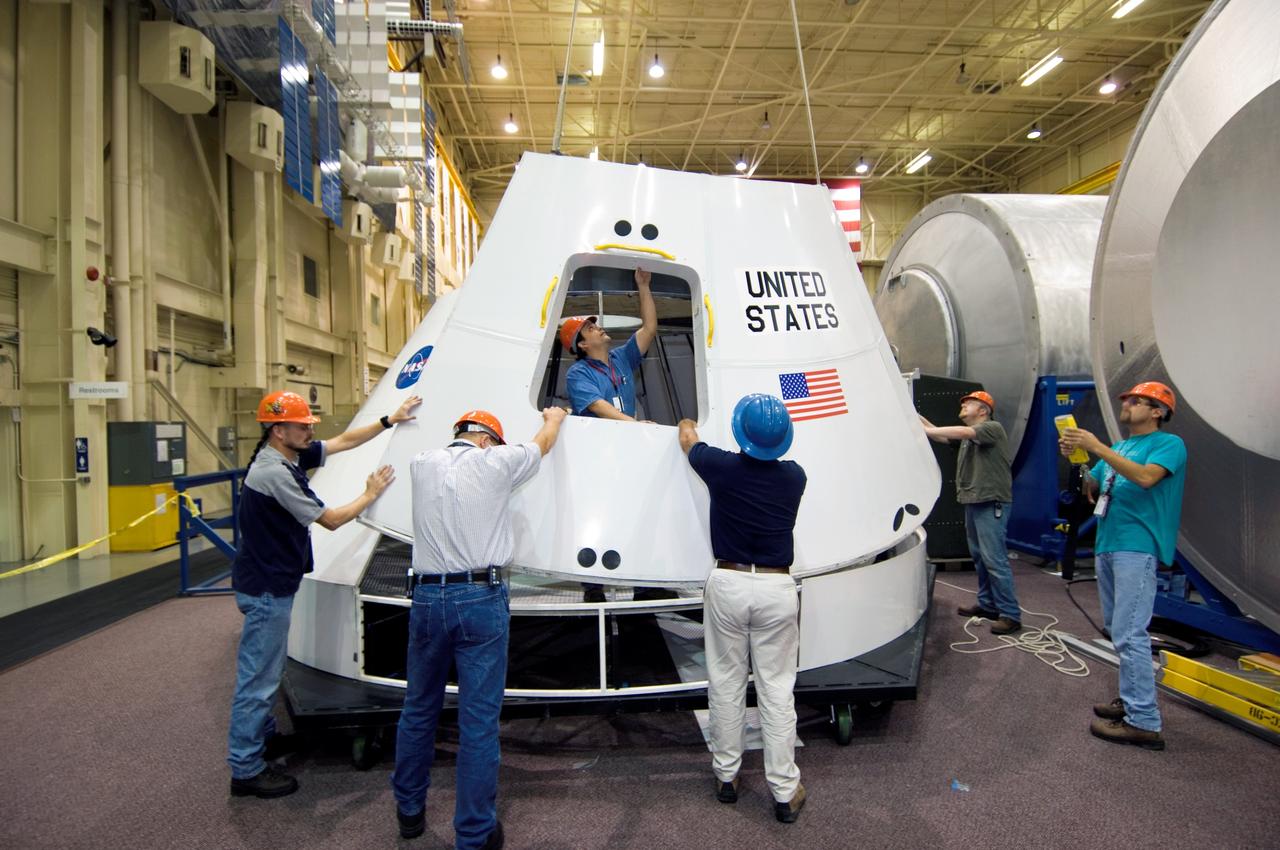 JSC2005-E-42348  (18 October 2005) --- NASA recently started assembling this full-sized mockup of the new Crew Exploration Vehicle's (CEV) cockpit in its Space Vehicle Mockup Facility at the Johnson Space Center. The CEV is the key to making NASA's Vision for Space Exploration a reality. Though the shape is reminiscent of the Apollo command modules of  four decades ago, the new capsule will be three times larger and is designed to carry four astronauts to and from the Moon, support up to six crew members on future missions to Mars and deliver crew and supplies to the international space station.