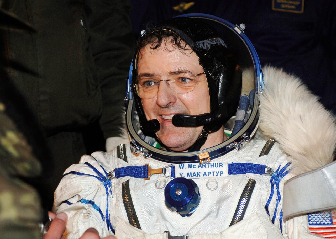 JSC2006-E-16021 (9 April 2006) --- Astronaut William S. McArthur Jr., Expedition 12 commander and space station science officer, smiles as he experiences terra firma for the first time in six months following the touchdown of the Soyuz TMA-7 spacecraft in the steppes of Kazakhstan. A Brazilian astronaut and Russian cosmonaut joined McArthur for the return trip from the orbital outpost. Photo Credit: NASA/Bill Ingalls