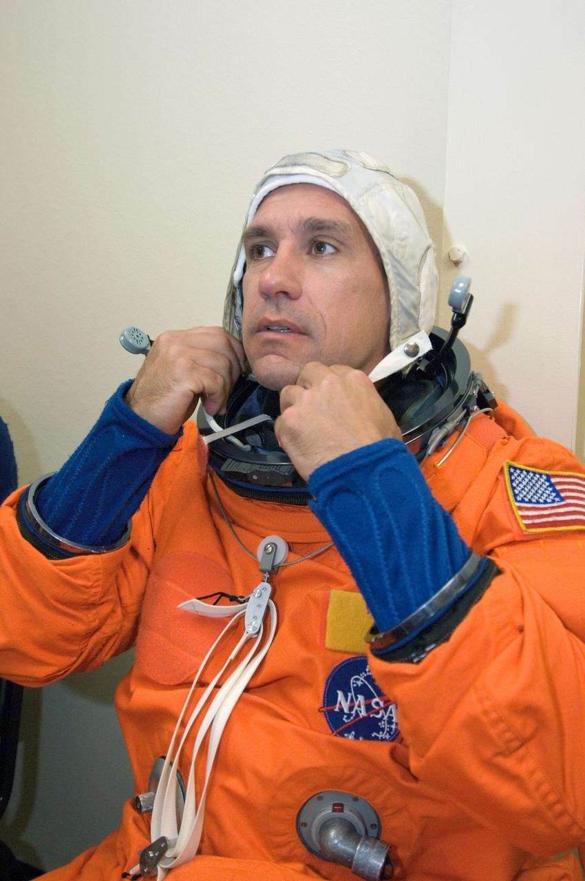 JSC2006-E-23021 (15 June 2006) --- Astronaut William A. Oefelein, STS-116 pilot, dons his training version of the shuttle launch and entry suit prior to a training session in the fixed-base shuttle mission simulator (SMS) in the Jake Garn Mission Simulation and Training Facility at Johnson Space Center.