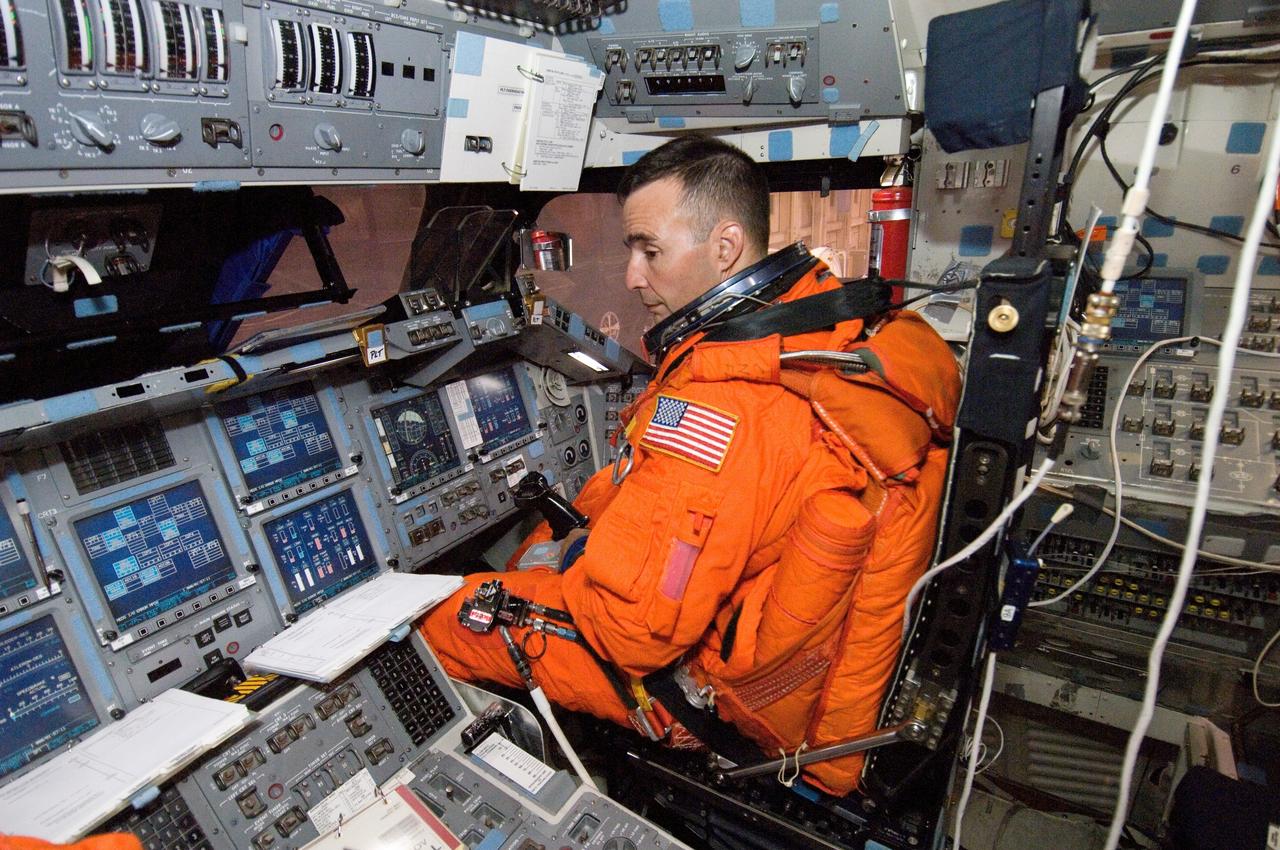 JSC2006-E-32653 (3 Aug. 2006) --- While seated at the pilot's station, astronaut Lee J. Archambault, STS-117 pilot, participates in a training session in the crew compartment trainer (CCT-2) in the Space Vehicle Mockup Facility at Johnson Space Center. Archambault is wearing a training version of his shuttle launch and landing suit.