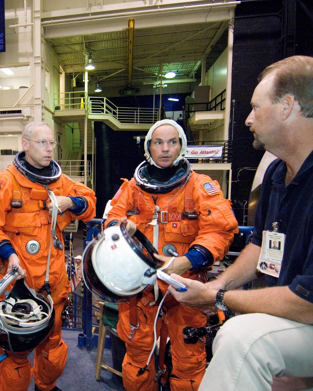 JSC2006-E-32682 (3 Aug. 2006) --- Attired in training versions of their shuttle launch and landing suits, astronauts Patrick G. Forrester (left) and Frederick W. (Rick) Sturckow, STS-117 mission specialist and commander, respectively, participate in a training session in the high fidelity mockup/trainers in the Space Vehicle Mockup Facility at Johnson Space Center. Trainer Robert H. Tomaro assisted Forrester and Sturckow.