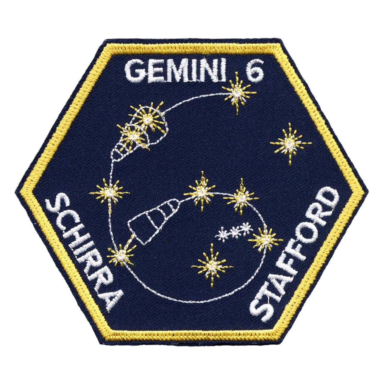 The Gemini 6 patch is hexagonal in shape, reflecting the mission number; and the spacecraft trajectory also traces out the number "6". The Gemini 6 spacecraft is shown superimposed on the "twin stars" Castor and Pollux, for "Gemini".