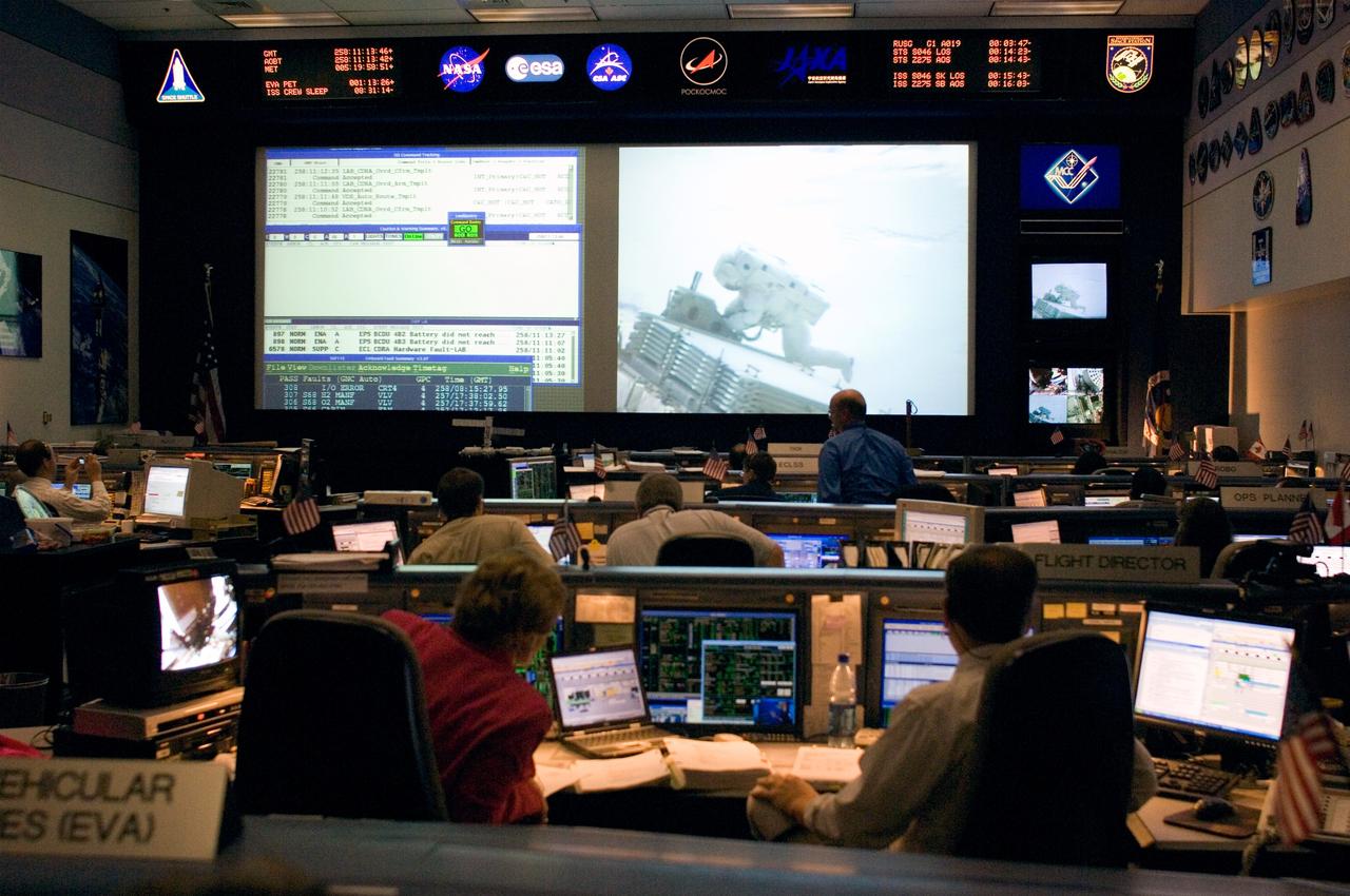 Expedition 13 Flight Controllers on console during mission - Orbit 2 - BFCR during EVA 3  Location: Bldg. 30south - BFCR