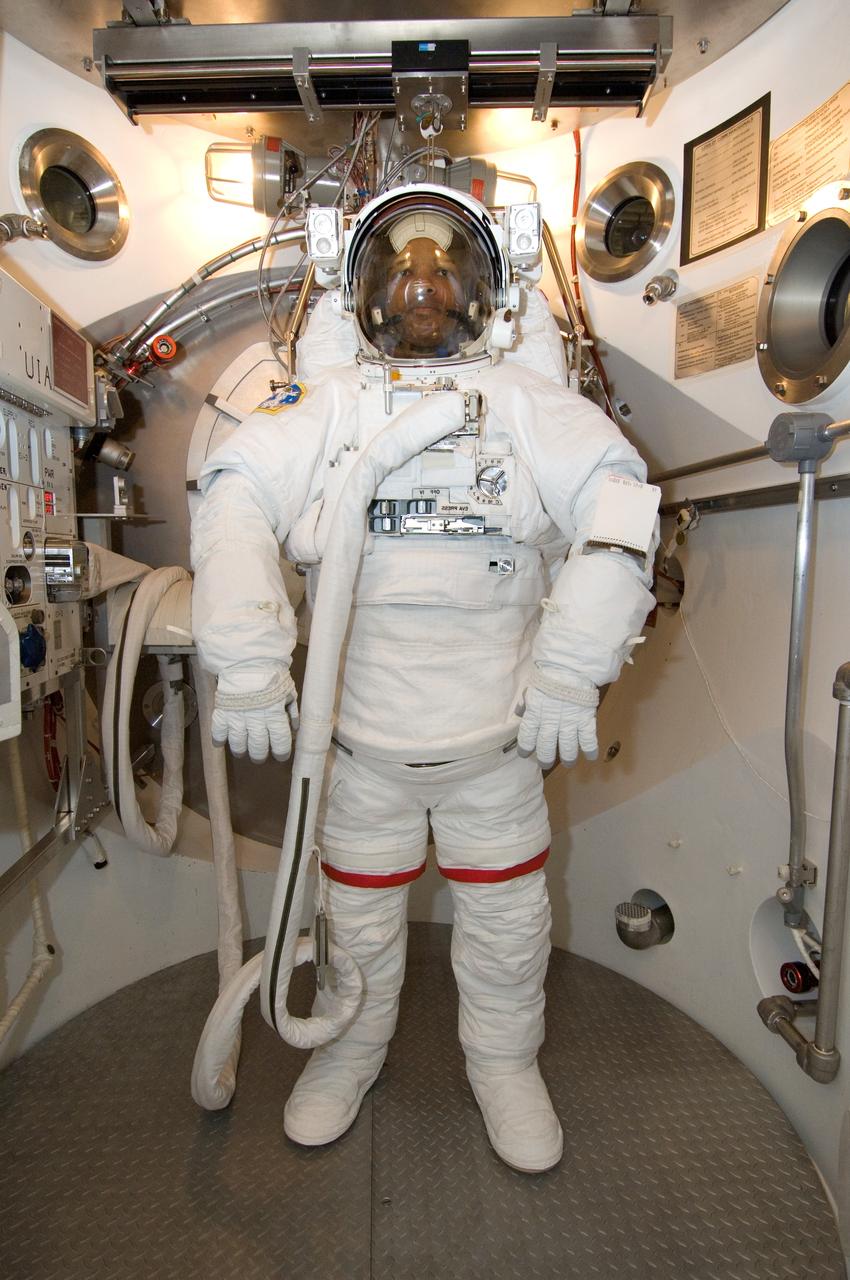 JSC2006-E-41656 (25 Sept. 2006) --- Astronaut Robert L. Curbeam, STS-116 mission specialist, participates in an Extravehicular Mobility Unit (EMU) spacesuit fit check in the Space Station Airlock Test Article (SSATA) in the Crew Systems Laboratory at the Johnson Space Center.