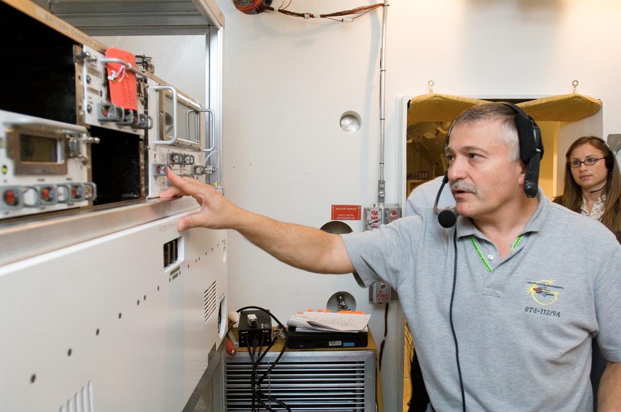 JSC2006-E-41803 (27 Sept. 2006) --- Cosmonaut Fyodor N. Yurchikhin, Expedition 15 commander representing Russia's Federal Space Agency, participates in an Extravehicular Mobility Unit (EMU) spacesuit fit check for cosmonaut Oleg V. Kotov (out of frame), flight engineer representing Russia's Federal Space Agency, in the Space Station Airlock Test Article (SSATA) in the Crew Systems Laboratory at Johnson Space Center.