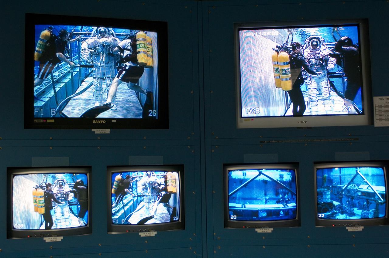 JSC2006-E-44666 (16 Oct. 2006) --- STS-117 underwater training activities in the waters of the Neutral Buoyancy Laboratory (NBL) near Johnson Space Center are visible on the monitors in the simulation control area in the NBL. The STS-117 crew is using the NBL to rehearse both assigned and contingency spacewalks for its scheduled February 2007 mission.