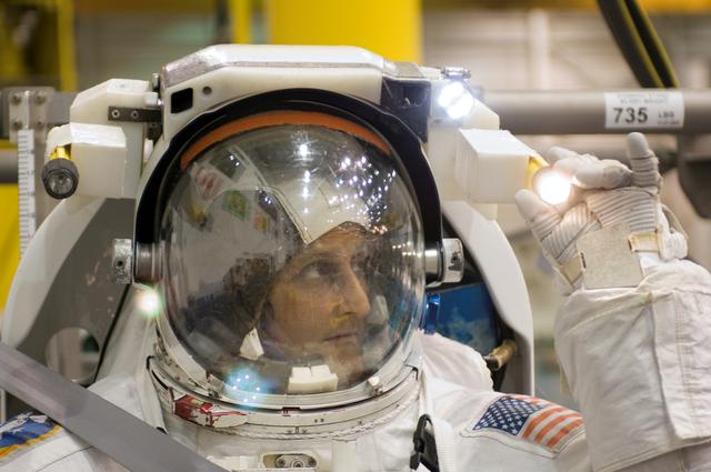 STS-116 crew members during EVA training at the NBL.
