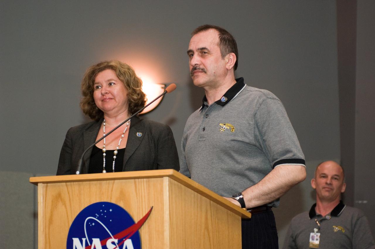 JSC2006-E-46700 (26 Oct. 2006) --- Cosmonaut Pavel V. Vinogradov (right), Expedition 13 commander representing Russia's Federal Space Agency, assisted by interpreter Irina Yashkova, speaks from the lectern in the ballroom of the Gilruth Center at Johnson Space Center during the welcome home ceremony for the Expedition 13 crewmembers.
