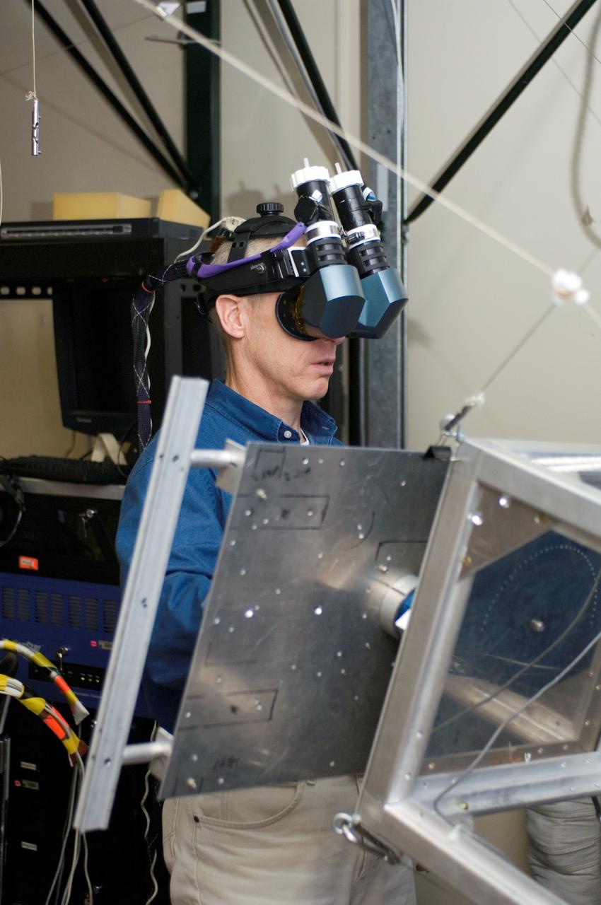 JSC2006-E-47421 (1 Nov. 2006) --- Astronaut Patrick G. Forrester, STS-117 mission specialist, uses virtual reality hardware in the Space Vehicle Mockup Facility at Johnson Space Center to rehearse some of his duties on the upcoming mission to the International Space Station. This type of virtual reality training allows the astronauts to wear a helmet and special gloves while looking at computer displays simulating actual movements around the various locations on the station hardware with which they will be working.