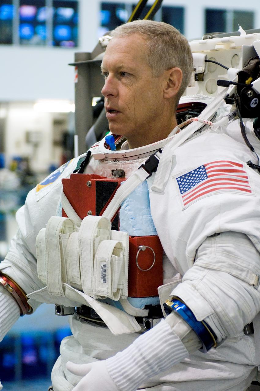 JSC2006-E-48963 (9 Nov. 2006) --- Astronaut Patrick G. Forrester, STS-117 mission specialist, dons a training version of the Extravehicular Mobility Unit (EMU) spacesuit prior to being submerged in the waters of the Neutral Buoyancy Laboratory (NBL) near Johnson Space Center.