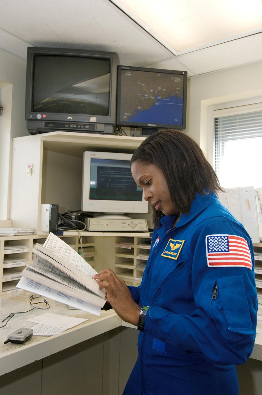 JSC2006-E-49040 (13 Nov. 2006) --- Astronaut Joan E. Higginbotham, STS-116 mission specialist, looks over a directory in the check-out facility at Ellington Field near Johnson Space Center prior to a flight in a NASA T-38 trainer jet to the Kennedy Space Center, Florida.