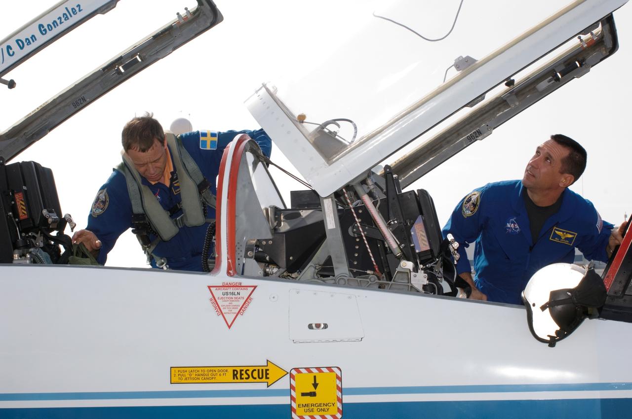 JSC2006-E-49051 (13 Nov. 2006) --- Astronauts William A. (Bill) Oefelein (right), STS-116 pilot, and Christer Fuglesang, mission specialist representing the European Space Agency (ESA), go through a pre-flight check of the systems of a NASA T-38 jet trainer at Ellington Field near Johnson Space Center prior to a flight to the Kennedy Space Center, Florida.