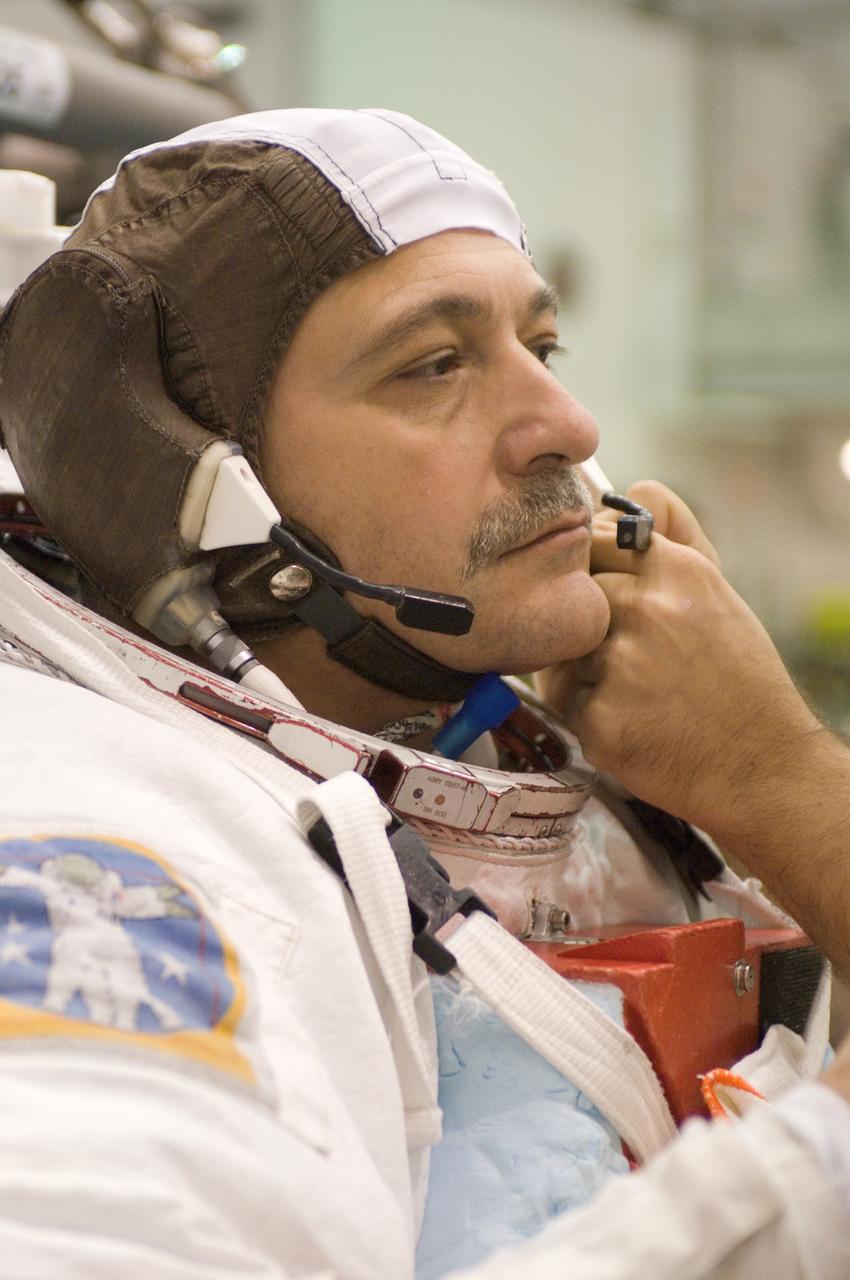 JSC2006-E-49769 (16 Nov. 2006) --- Cosmonaut Fyodor N. Yurchikhin, Expedition 15 commander representing Russia's Federal Space Agency, dons a training version of the Extravehicular Mobility Unit (EMU) space suit prior to being submerged in the waters of the Neutral Buoyancy Laboratory (NBL) near the Johnson Space Center. Suit technicians assisted Yurchikhin.