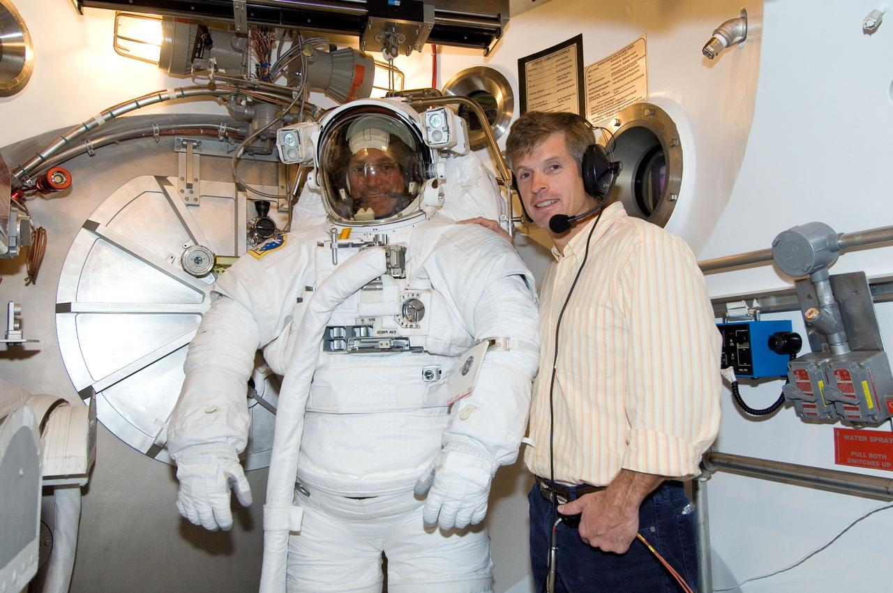 JSC2006-E-53024 (4 Dec. 2006) --- Astronaut John D. (Danny) Olivas, STS-117 mission specialist, participates in an Extravehicular Mobility Unit (EMU) spacesuit fit check in the Space Station Airlock Test Article (SSATA) in the Crew Systems Laboratory at the Johnson Space Center. Astronaut Steven R. Swanson, mission specialist, assisted Olivas.