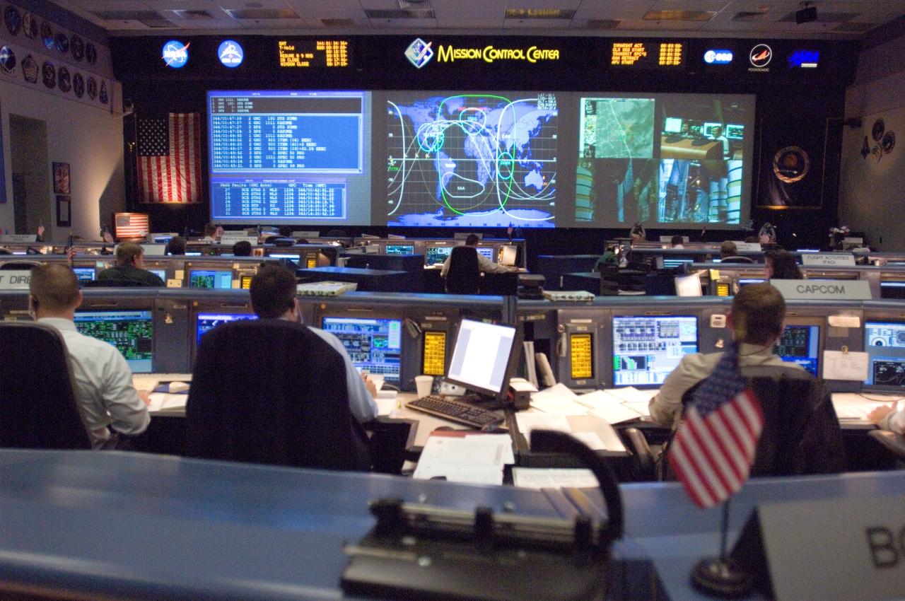 JSC2006-E-53518 (9 Dec. 2006) --- Overall view in the shuttle flight control room, from the point of view of the Booster console, on launch day for STS-116. Steve Stich (center) and Norm Knight (far left), ascent and entry flight directors, respectively, are seated at their consoles.
