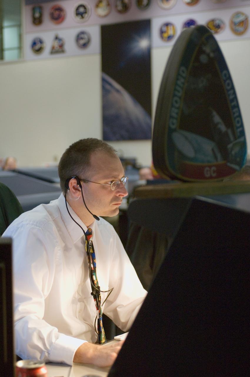 JSC2006-E-53585 (11 Dec. 2006)  --- Aaron Frith, ground controller (GC) works the Orbit 3 shift in the Shuttle Flight Control Room for the STS-116 mission.