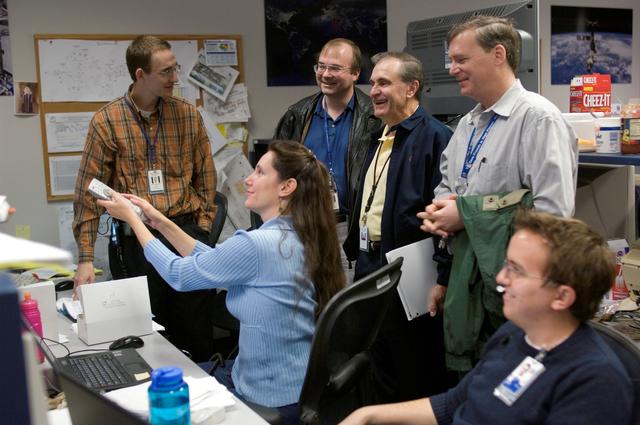 NASA image: STS-116 Flight Controllers on console during mission - Orbit 3